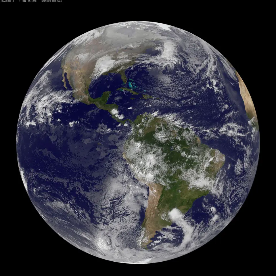 Earth seen from space, half in sunlight, with the Americas visible.